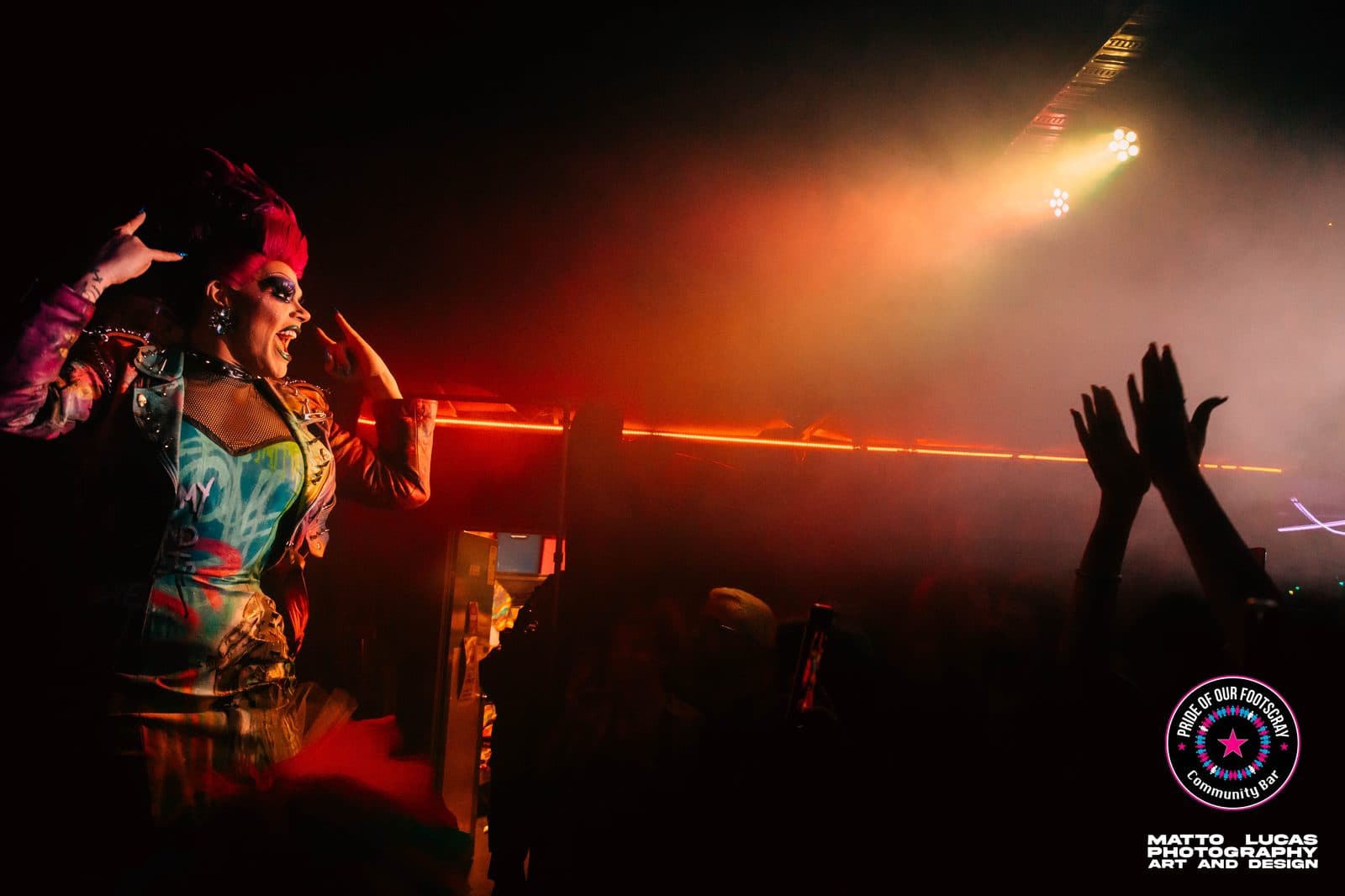 Drag performer with a pink mohawk performing to a crowd at Pride of our Footscray
