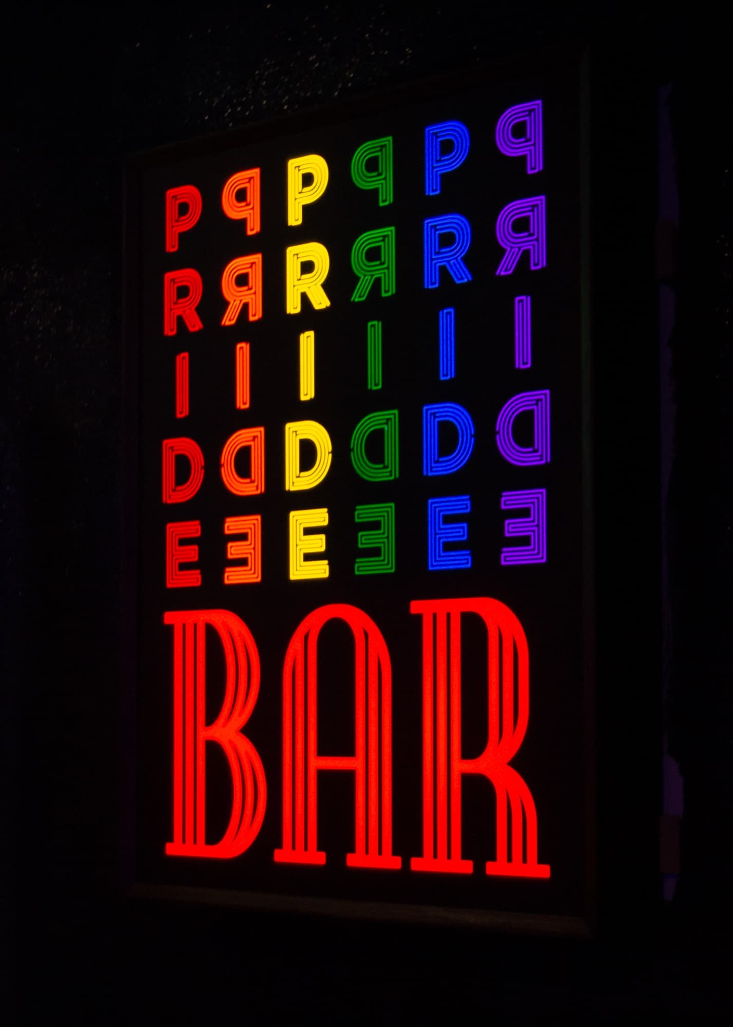 The illuminated PRIDE sign inside the venue